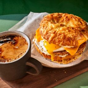 Sausage Over Easy Egg Asiago Sandwich with a hot coffee from Panera