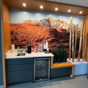 Jeff Wyler Chrysler Dodge Jeep Ram of Fort Thomas refreshment area showcased in this photo, offering complimentary coffee, water, and beverages for guests while they wait for vehicle service or sales appointments