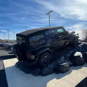 Jeff Wyler Chrysler Dodge Jeep Ram of Fort Thomas showcased in this photo, featuring a Jeep on an inclined rock display highlighting its off-road capability and rugged performance for adventure-ready drivers in Northern Kentucky.