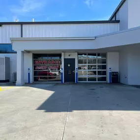 Jeff Wyler Chrysler Dodge Jeep Ram of Fort Thomas Service Department showcased in this photo, featuring garage doors designed like windows, including one marked ‘Entrance, Sound Horn,’ providing convenient and organized access for vehicle drop-offs and maintenance.