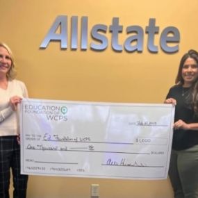 Alex presents a $1000 Allstate Foundation Helping Hands grant Shelia Evers (left) from the Education Foundation of Washington County Public Schools.