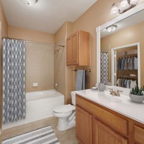 Bathroom with soaking bathtub and tile surround