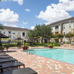 Outdoor grills, dining areas, and sun loungers at Camden Downs at Cinco Ranch in Katy, TX.