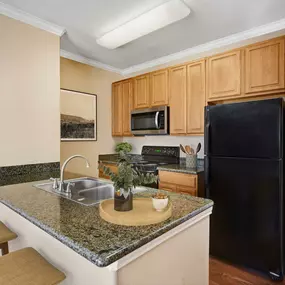 Kitchen with granite countertops and bar seating