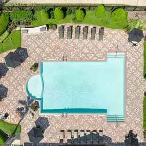 Resort-style pool with outdoor grills and covered seating