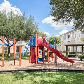 Onsite playground, green space, and picnic seating at Camden Downs at Cinco Ranch in Katy, TX.