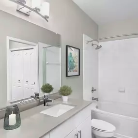 Bathroom with quartz countertops and rainfall showehead