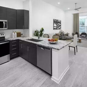 Kitchen with stainless steel appliances and tall ceilings at Camden Dulles Station apartments in Herndon, VA