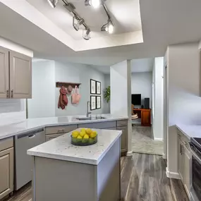 Kitchen island quartz countertops and greige cabinets near a home office