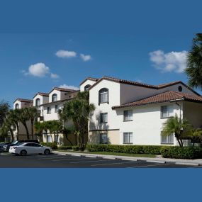 Building exterior showing spanish tile and uncovered parking