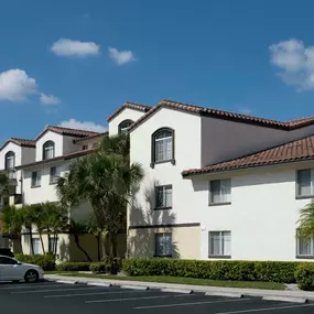 Building exterior showing spanish tile and uncovered parking