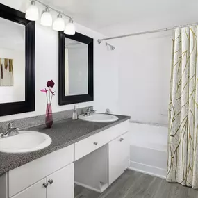 Bathroom with double vanity sinks at Camden Portofino apartments in Pembroke Pines, FL