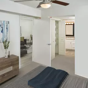 Bedroom with ensuite bathroom ceiling fan and carpet flooring at Camden Portofino apartments in Pembroke Pines, FL