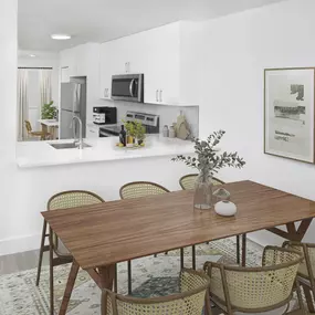 Open-concept dining and kitchen space in the Alberti floorplan at Camden Portofino in Pembrooke Pines, FL.