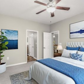 Bedroom with carpet, ceiling fan, and ensuite bathroom