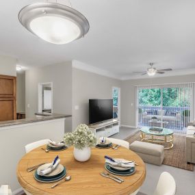 Dining area overlooking living room with sliding door to private balcony