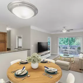 Dining area overlooking living room with sliding door to private balcony