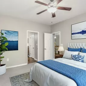 Bedroom with carpet, ceiling fan, and ensuite bathroom