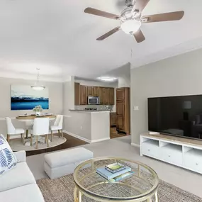 Living and dining area with carpet flooring and ceiling fan