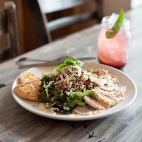 Some of our new additions to our menus are now some of our favorites! An example is this Chicken Waldorf Salad with organic lettuce, quinoa, red grapes & green apple with candied nuts and topped with gruyere cheese.  It is served with our grilled chicken breast and homemade Tipsy dressing!
