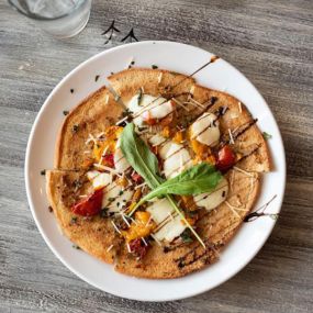 At Tipsy Chicken, we offer a gluten friendly flatbread! It has roasted tomatoes, garlic, basil, balsamic and fresh mozzarella on grilled gluten friendly flatbread from the lovely Clover Meadow Bakery.