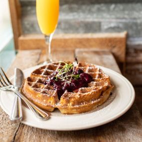 These waffles from Tipsy Chicken Kitchen & Cocktails are a true treat and melt in your mouth with fresh berries on top.