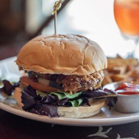 This is not your drive-through chicken sandwich!  Ours is a Large breaded fried organic chicken breast nestled on a toasted organic bakery bun with fresh tomato, lettuce medley, pickles, and choice of sauce... we HIGHLY recommend you chose our famous Tipsy sauce on this one!