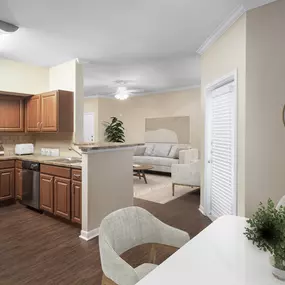 Dining area and kitchen with wood-style flooring at Camden Centreport apartments in Fort Worth, Texas