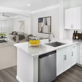 Contemporary kitchen with open-concept living and dining rooms at Camden Overlook Apartments in Raleigh, NC.