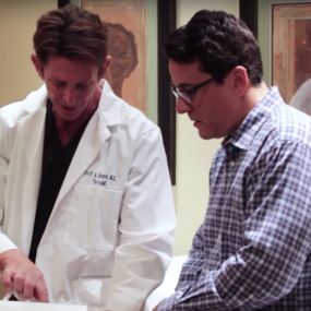 Scott Brandt, MD, with a stem cell patient who received knee treatments.