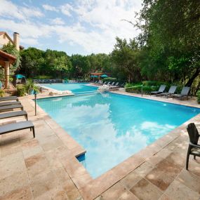 Pool with volleyball net and lounge chairs