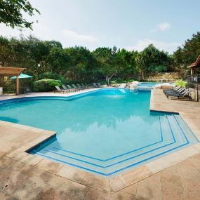 Pool with barbeque grills and outdoor dining area