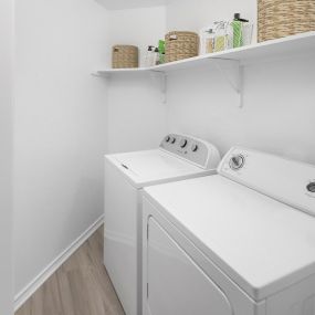 Laundry room with washer and dryer and built-in shelf at Camden Gaines Ranch