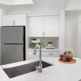 Kitchen with white quartz countertops, white cabinets and gray subway-tile backsplash