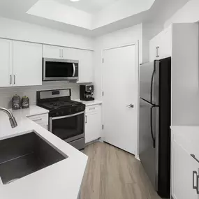 Kitchen with white countertops, white cabinets and light gray subway tile backsplash at Camden Gaines Ranch