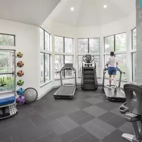 24-hour fitness center with treadmills, stair climber, and strength equipment at Camden Gaines Ranch apartments in Austin, TX