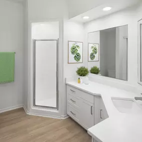 Bathroom with walk-in shower, white cabinets and white quartz countertops