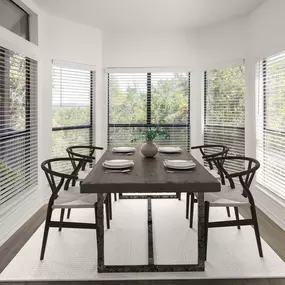 Dining area with bay windows and wood-style flooring at Camden Gaines Ranch apartments in Austin, TX