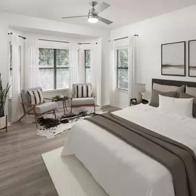 Bedroom with bay windows and wood-style flooring at Camden Gaines Ranch apartments in Austin, TX