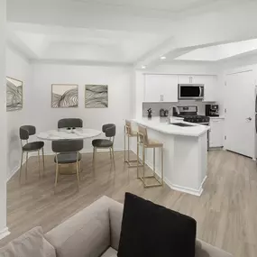 Dining room and kitchen with white countertops and light gray wood-style floors at Camden Gaines Ranch