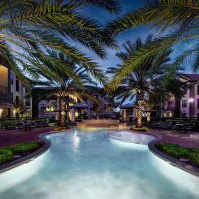 Beach style pool with tanning shelf grills and dining areas