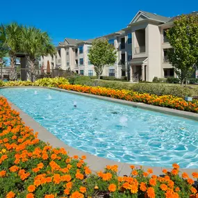 Beach style pool with water features