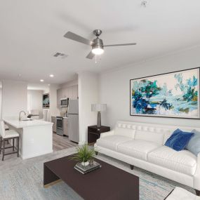 Open concept living room with lighted ceiling fan and renovated kitchen