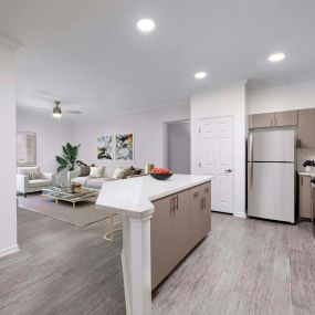 Open-concept luxury kitchen with stainless steel appliances and white quartz countertops at Camden Landmark Apartments in Ontario CA