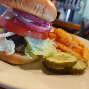 Greek Burger is a 1/3 lb. beef patty with lettuce, tomato and red onion topped with feta cheese and housemade gyro sauce - served with fries for only $7.99.