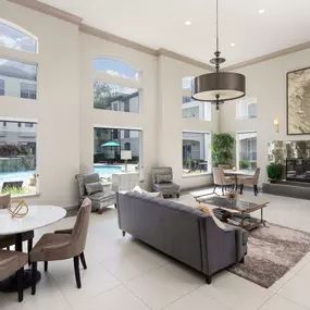 Resident clubroom with views of the resort-style pool at Camden Midtown Apartments in Houston, TX