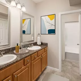 Traditional style with double sink vanity and large soaking bathtub at Camden Midtown Apartments in Houston, TX