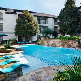 Resort-style pool with sun loungers at Camden Midtown Apartments in Houston, TX