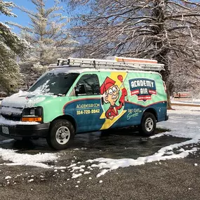Academy Air Heating, Cooling, Plumbing and Electric van outside in snow