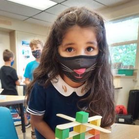 Students in Suite B tackle some engineering challenges— exploring structural design by making a tower out of popsicle sticks, blocks and cups.